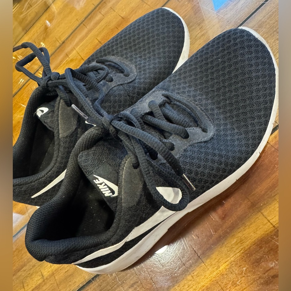 Nike black, mesh sneakers gently worn. Size 4 youth.